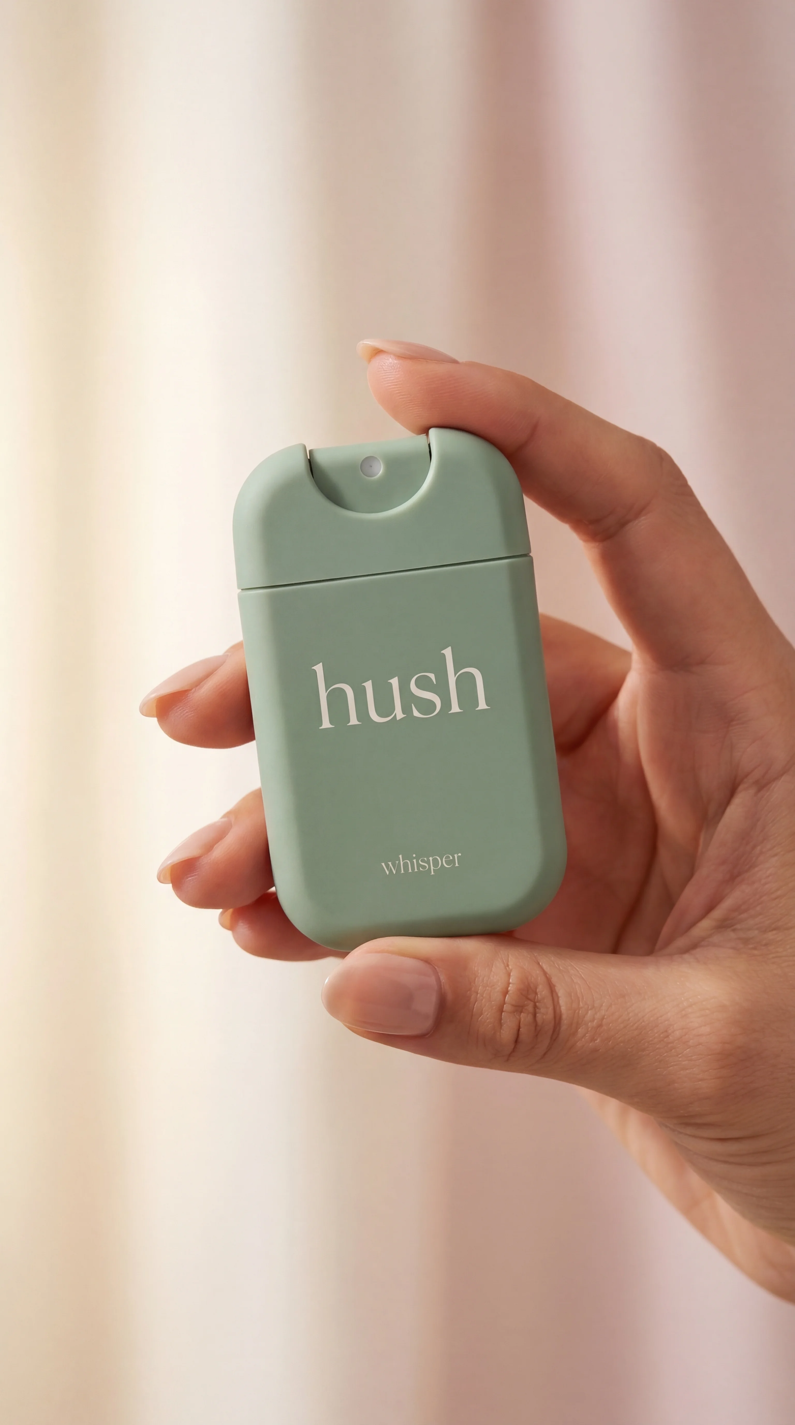 Hush Whisper held in a woman's hand — showing how tiny and pocket-sized it is